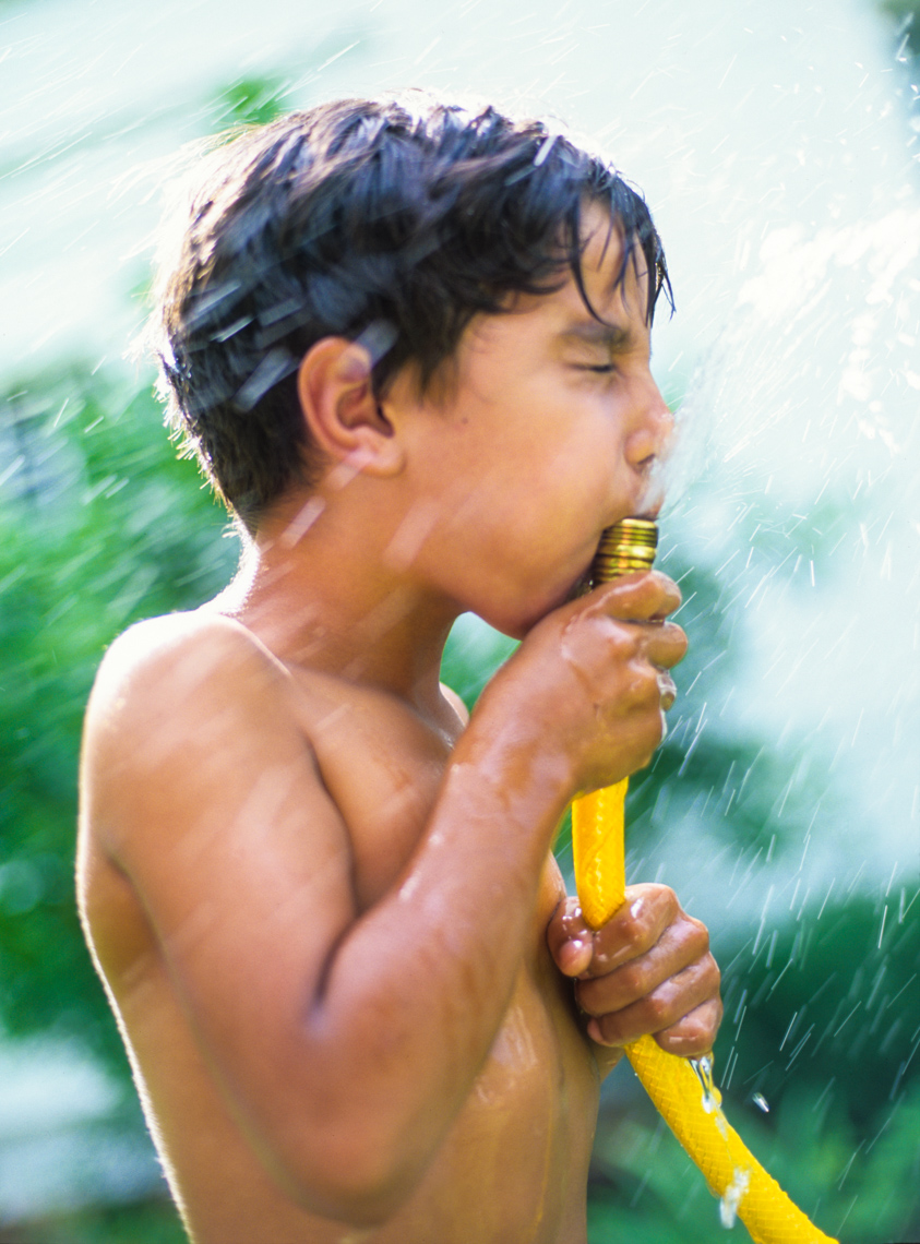 Boy squirting water | Kids Lifestyle Photographer