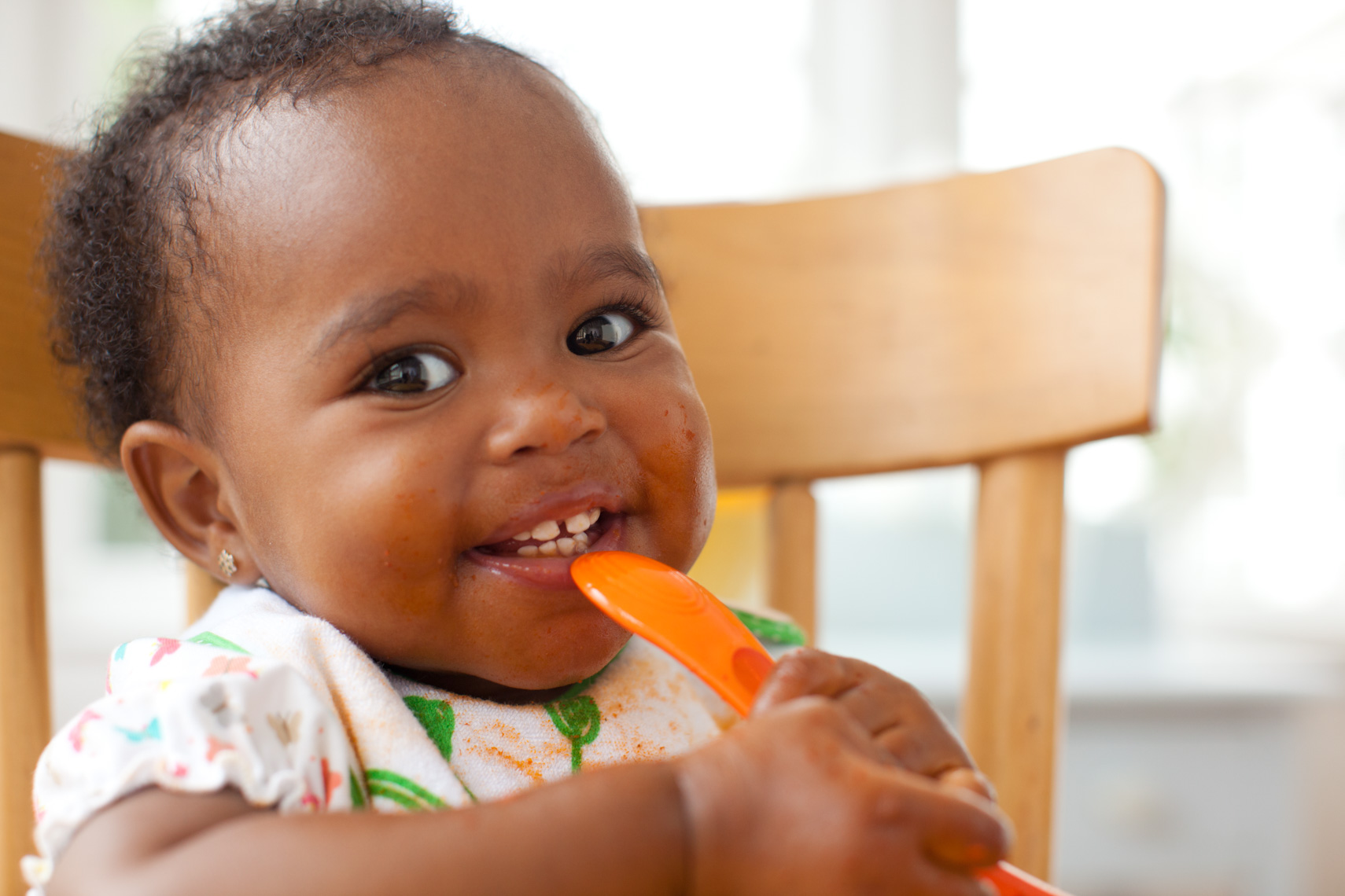 Baby eating in highchair | Commercial Kids Photographer