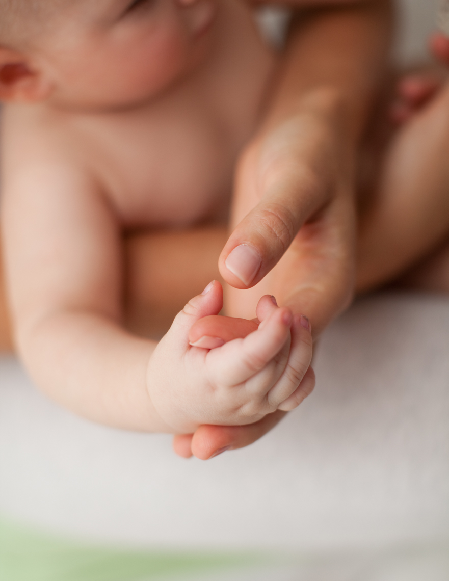 Baby holding mom