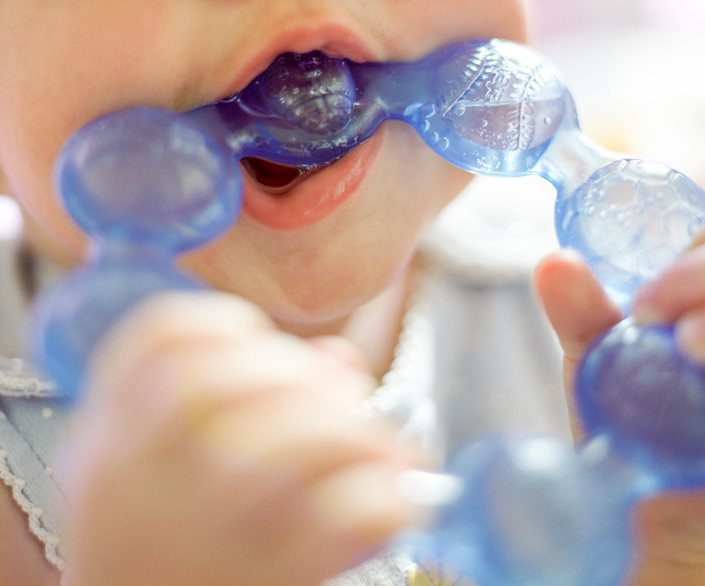 Baby sucking teething ring | Kids Lifestyle Photographer
