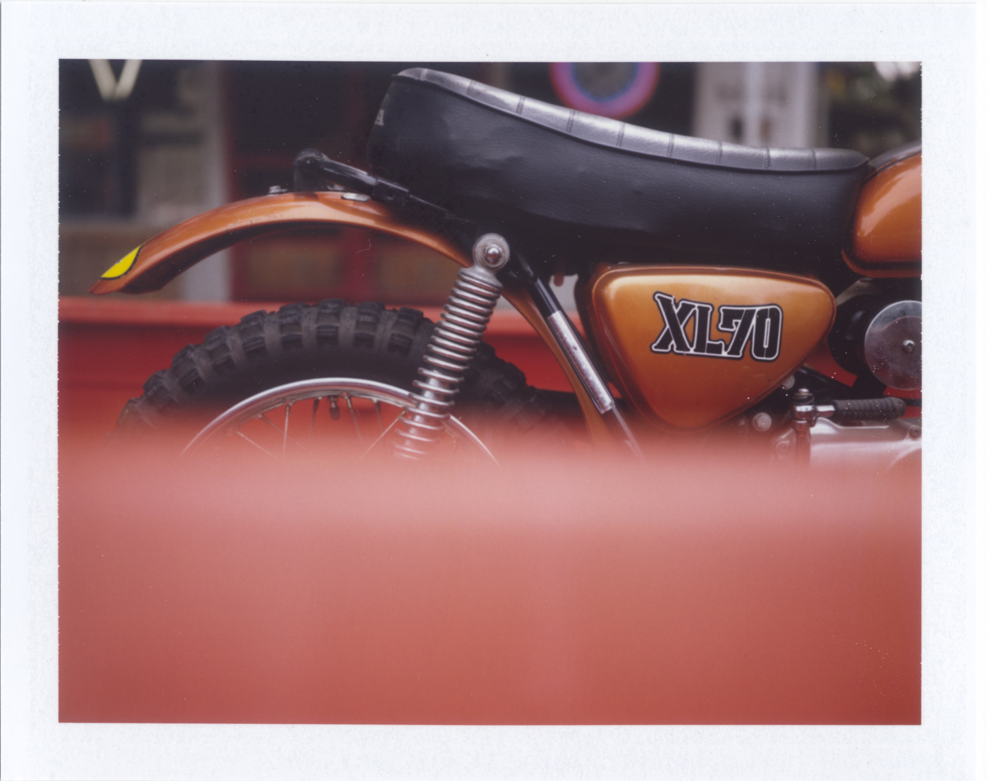 Orange motorcycle shot on Polaroid 