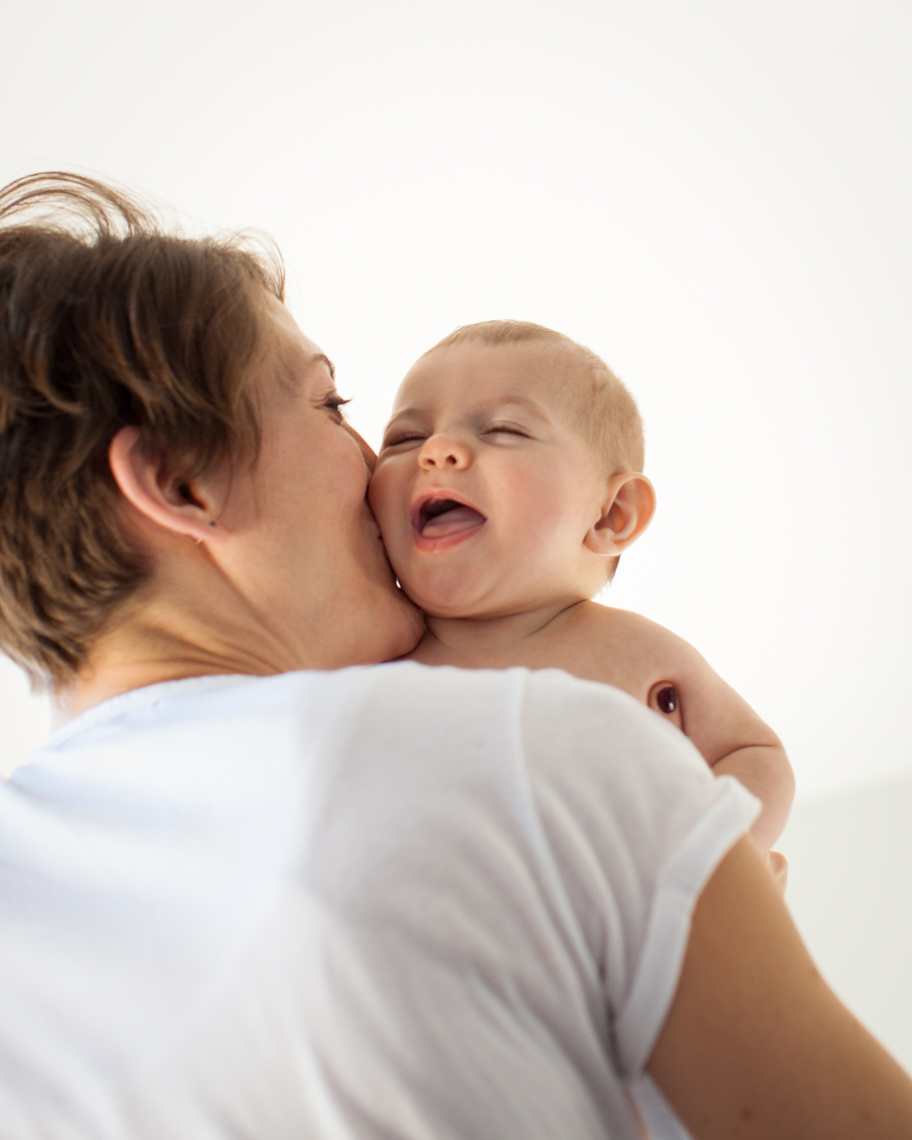 Joyous mom kissing baby | Kids Lifestyle Photographer