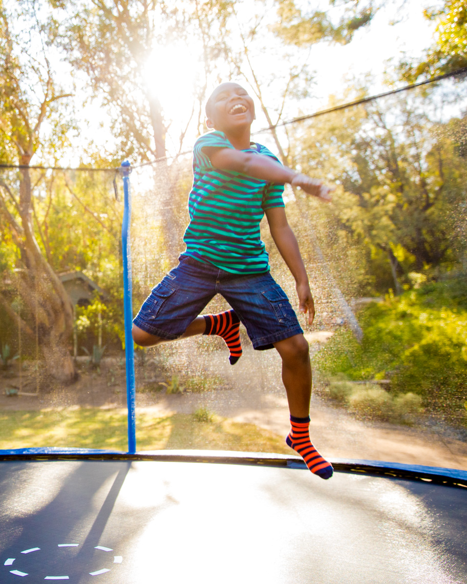 Upbeat boy on trampoline | Commercial Lifestyle Photographer
