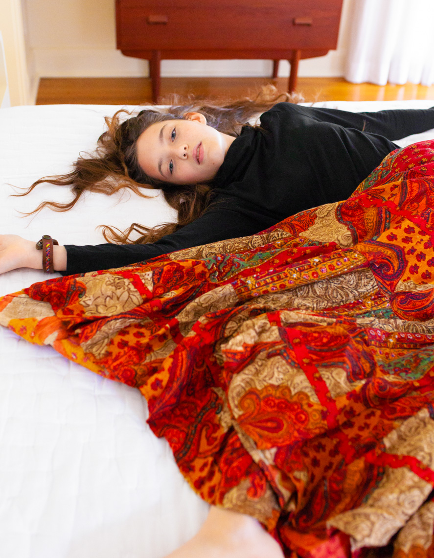 Girl laying down in orange skirt | Fashion Lifestyle Photographer