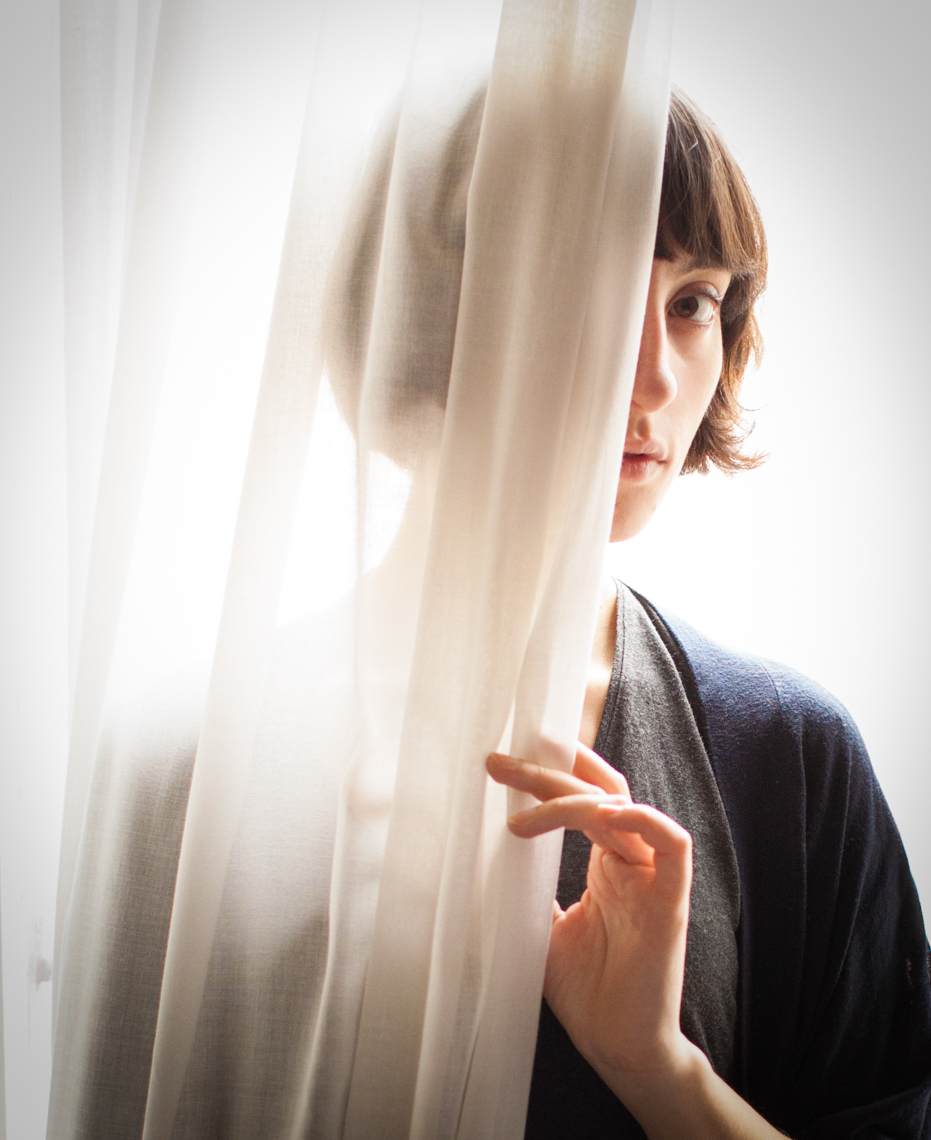 Girl peeking from curtain | Editorial Portrait Photographer