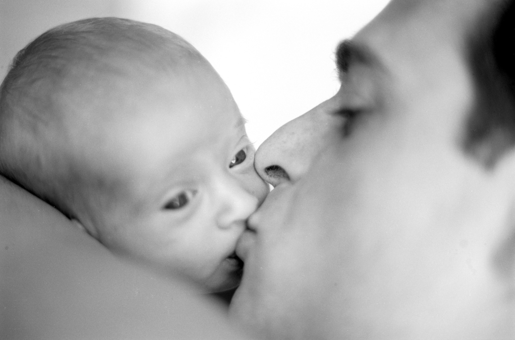 New dad kissing newborn | Visual Storytelling Photographer