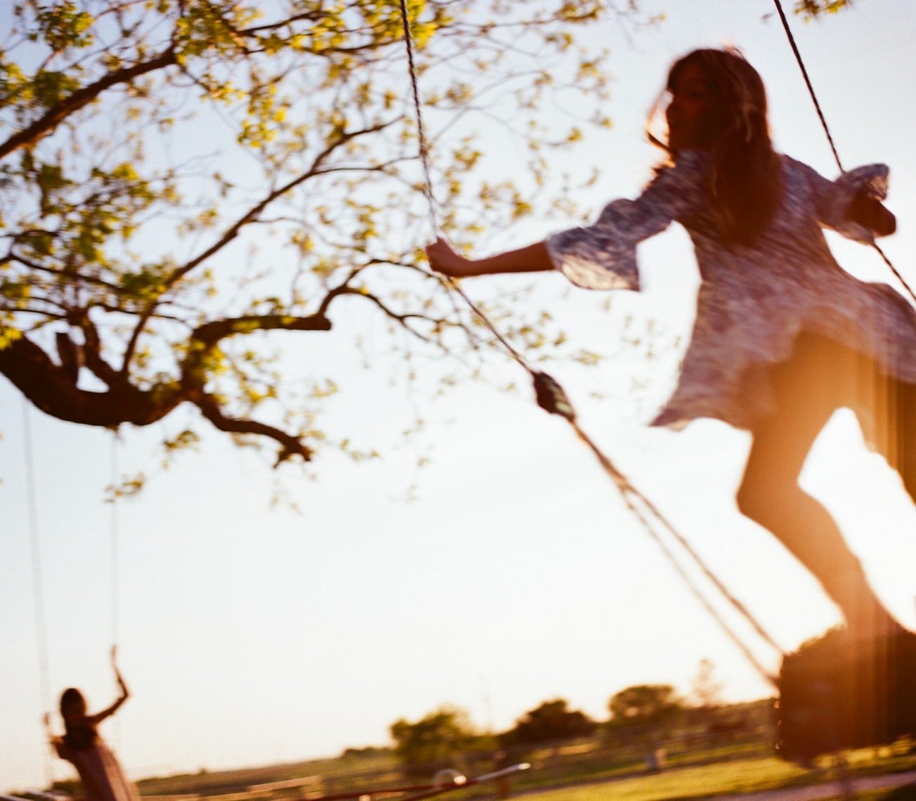 Carefree girl on tree swing | Visual Storytelling Photographer