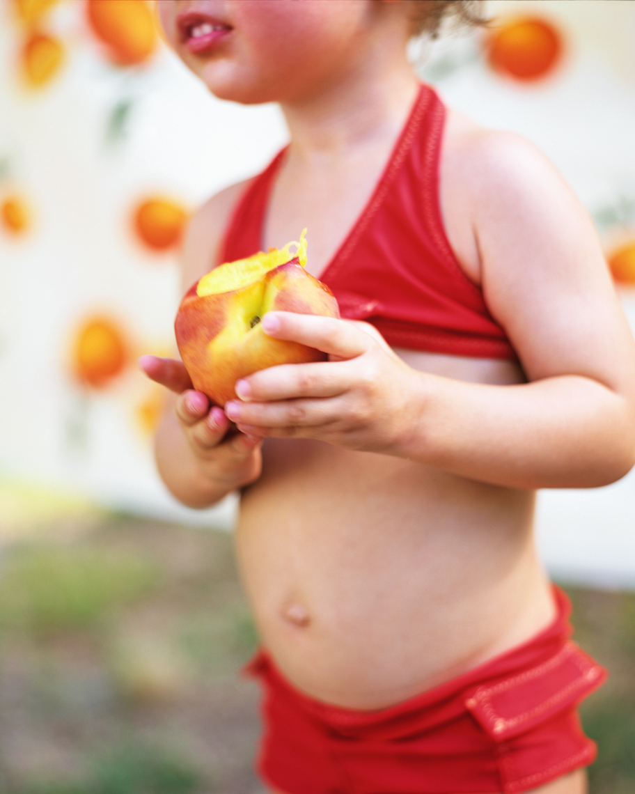 Young child eating fruit | Visual Storytelling Photographer