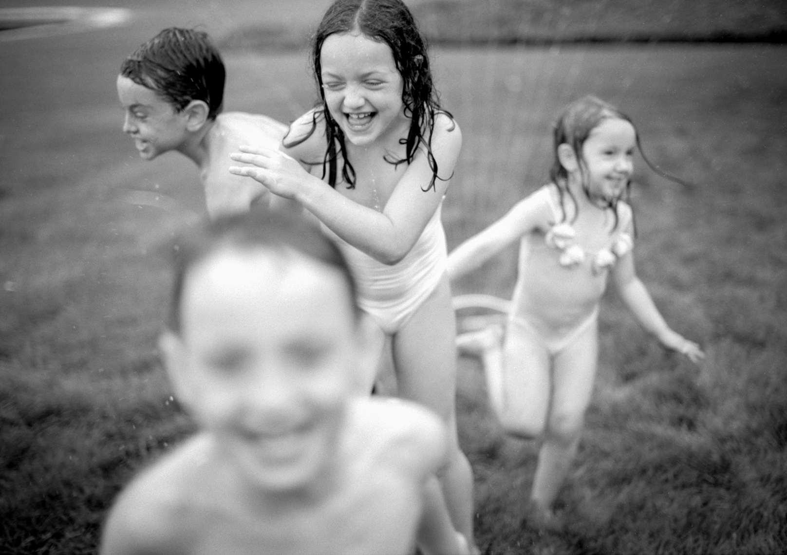 Active kids running in sprinkler | Kids Lifestyle Photographer