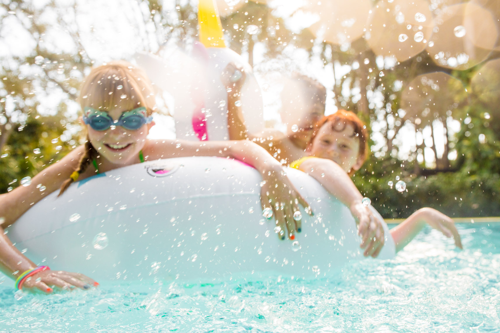 Cheery kids on pool float | Commercial Lifestyle Photographer