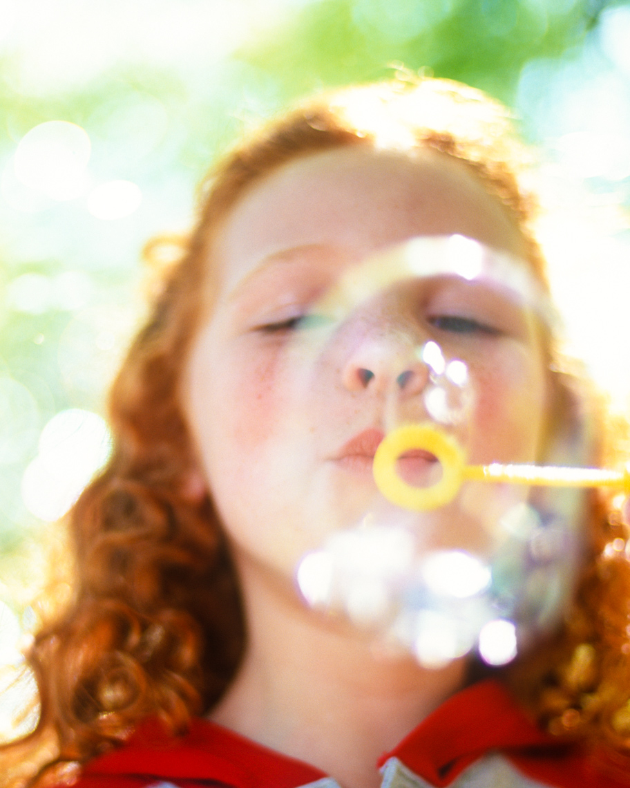 Child blowing bubbles | Visual Storytelling Photographer